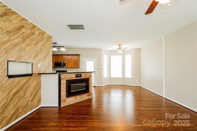 kitchen with dark wood-type flooring and ceiling fan