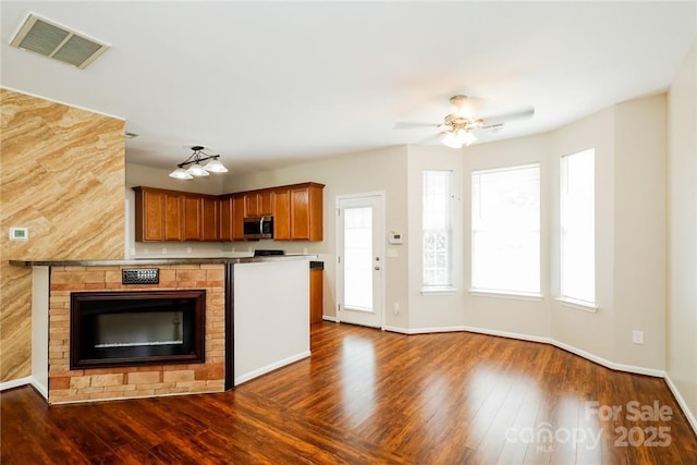 kitchen featuring ceiling fan and dark hardwood / wood-style floors