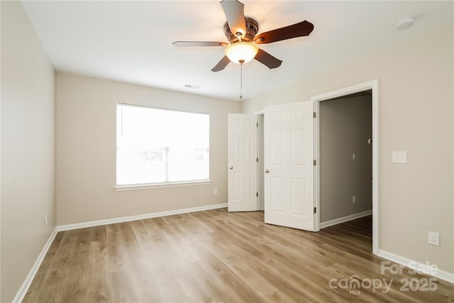 unfurnished bedroom featuring ceiling fan and light wood-type flooring