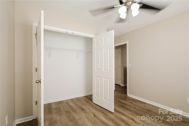 unfurnished bedroom with hardwood / wood-style floors, ceiling fan, and a closet