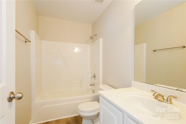 full bathroom with vanity, toilet, shower / washtub combination, and hardwood / wood-style floors