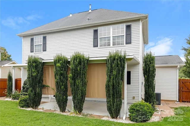 rear view of property with a yard and cooling unit