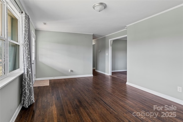 empty room featuring ornamental molding and dark hardwood / wood-style flooring