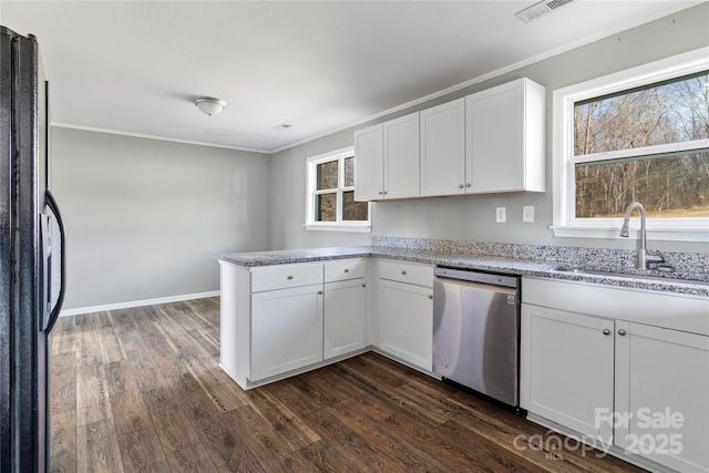 kitchen featuring sink, white cabinets, black fridge, stainless steel dishwasher, and kitchen peninsula