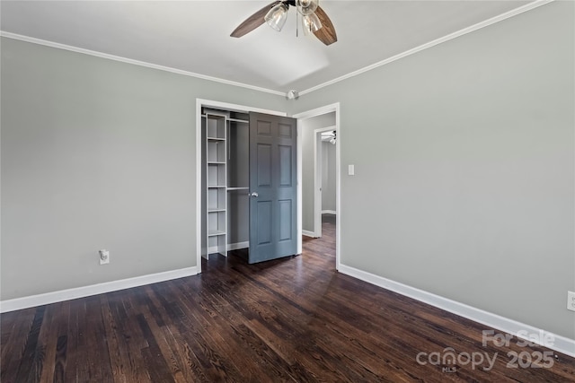 unfurnished bedroom featuring ceiling fan, ornamental molding, dark hardwood / wood-style flooring, and a closet