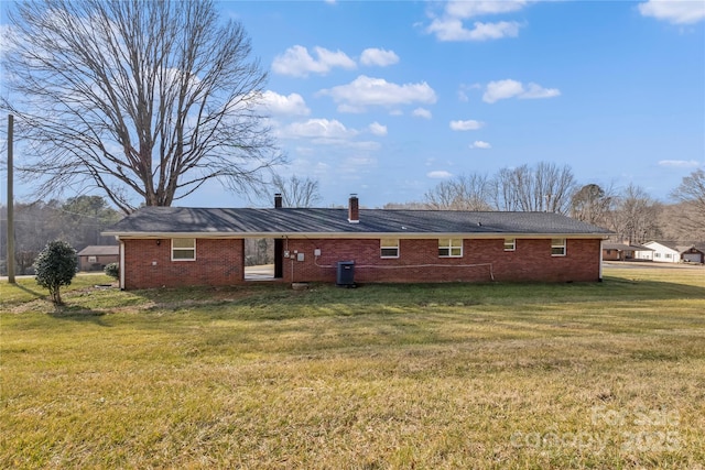 back of house featuring cooling unit and a yard