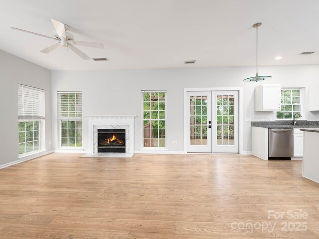 172 Foxtail Dr, Mooresville, NC 28117 - unfurnished living room featuring light wood-type flooring, ceiling fan, recessed lighting, a premium fireplace, and baseboards