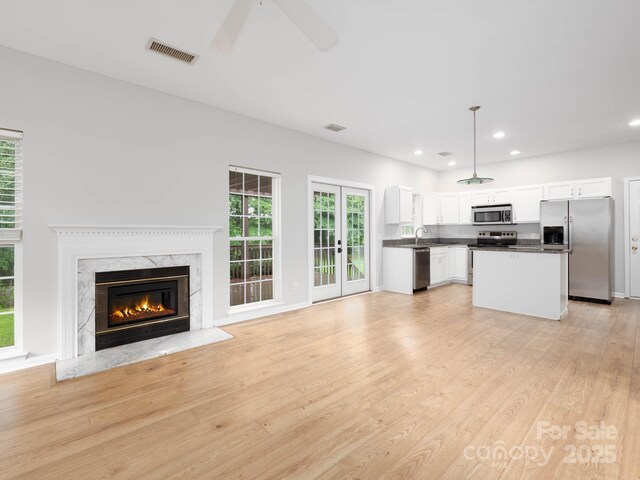 172 Foxtail Dr, Mooresville, NC 28117 - unfurnished living room featuring a fireplace, a ceiling fan, light wood-style flooring, recessed lighting, and a sink