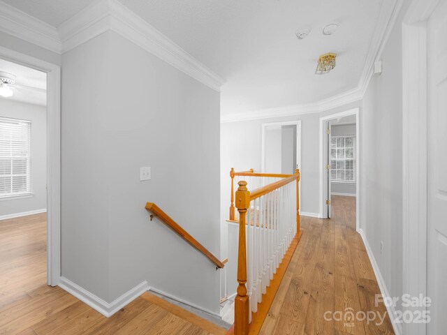 172 Foxtail Dr, Mooresville, NC 28117 - hallway featuring an upstairs landing, light wood-style floors, baseboards, and ornamental molding