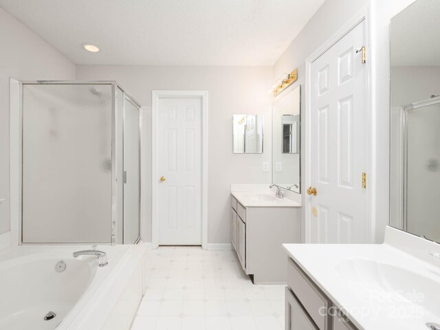 172 Foxtail Dr, Mooresville, NC 28117 - bathroom with a shower stall, two vanities, a garden tub, and tile patterned floors