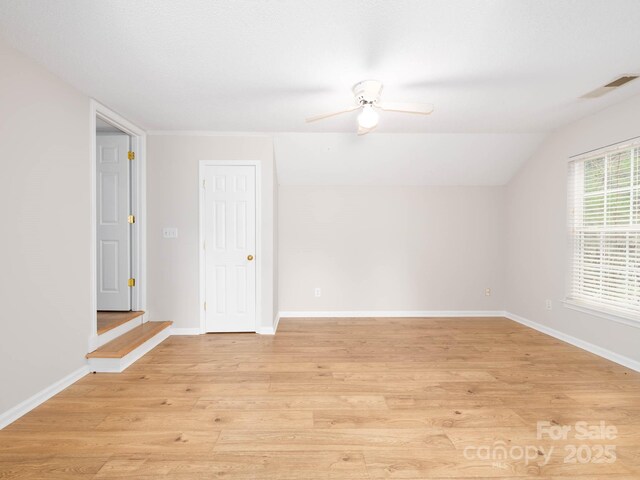 172 Foxtail Dr, Mooresville, NC 28117 - spare room featuring light wood finished floors, a ceiling fan, baseboards, and lofted ceiling
