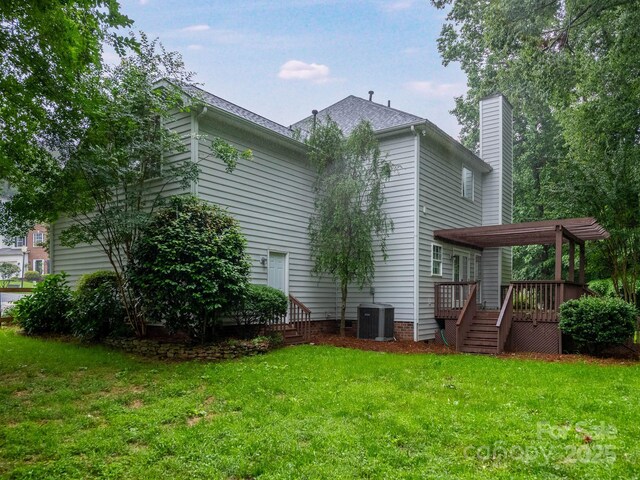 172 Foxtail Dr, Mooresville, NC 28117 - rear view of house with central AC, a wooden deck, a yard, and a chimney