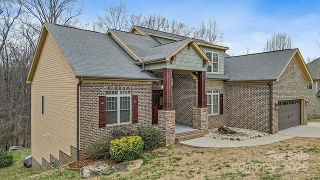 craftsman inspired home featuring a garage and covered porch