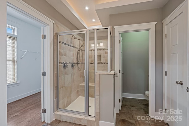 bathroom featuring walk in shower and toilet