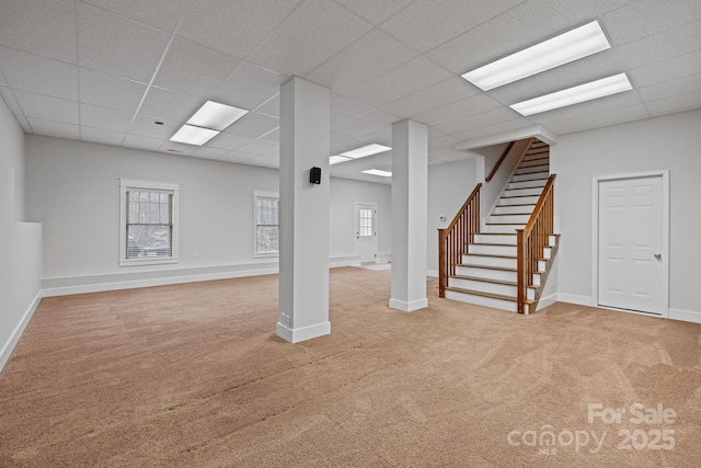 basement featuring carpet floors and a drop ceiling