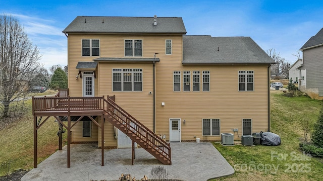 back of property with a yard, a deck, central air condition unit, and a patio area