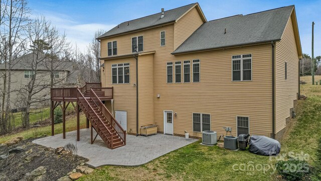 rear view of house with a patio, a yard, central AC, and a deck