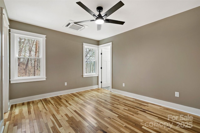 unfurnished bedroom featuring visible vents, baseboards, ceiling fan, and light wood finished floors