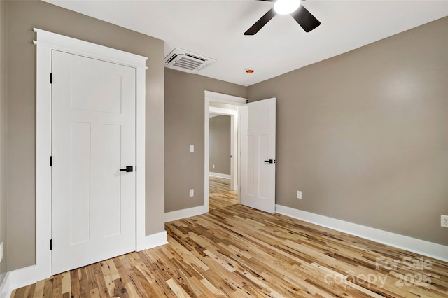 unfurnished bedroom featuring visible vents, baseboards, light wood-style floors, and a ceiling fan