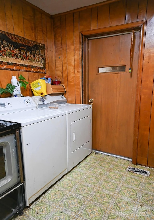 316 E 4th Ave, Gastonia, NC 28054 - washroom featuring washing machine and dryer, laundry area, wood walls, and light floors