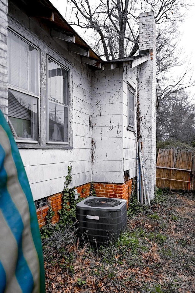 316 E 4th Ave, Gastonia, NC 28054 - view of home's exterior featuring crawl space, a chimney, cooling unit, and fence