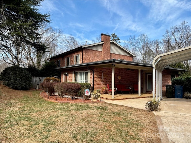 view of property exterior with a yard and a carport