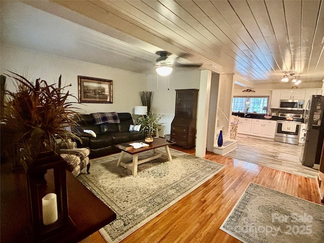 living room featuring wood ceiling and light hardwood / wood-style floors