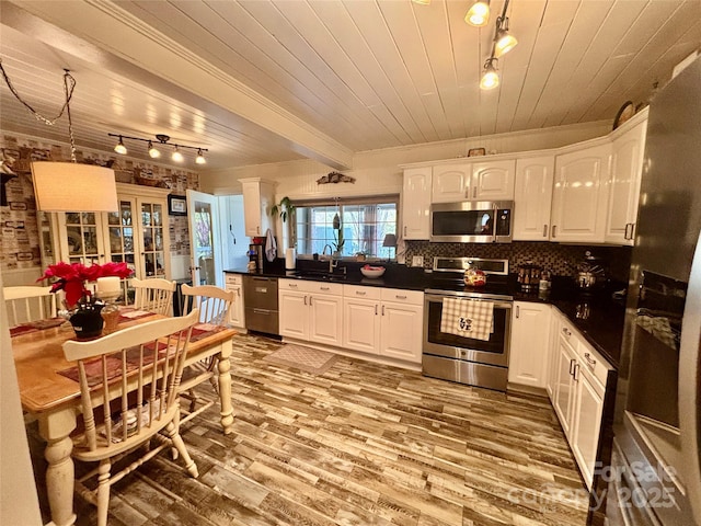 kitchen featuring sink, light wood-type flooring, wooden ceiling, stainless steel appliances, and white cabinets