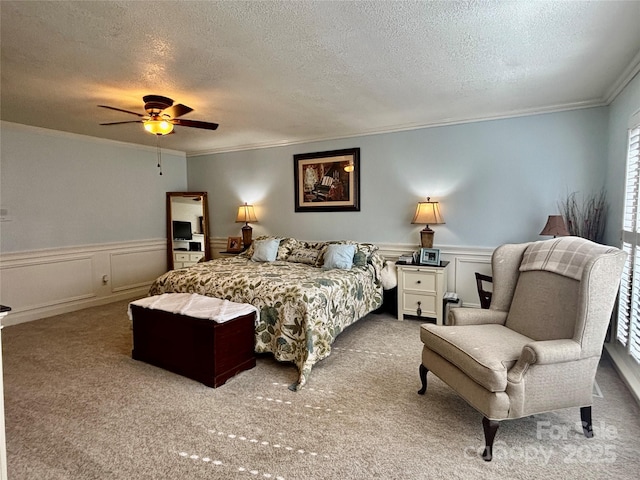 bedroom with ceiling fan, ornamental molding, light colored carpet, and a textured ceiling