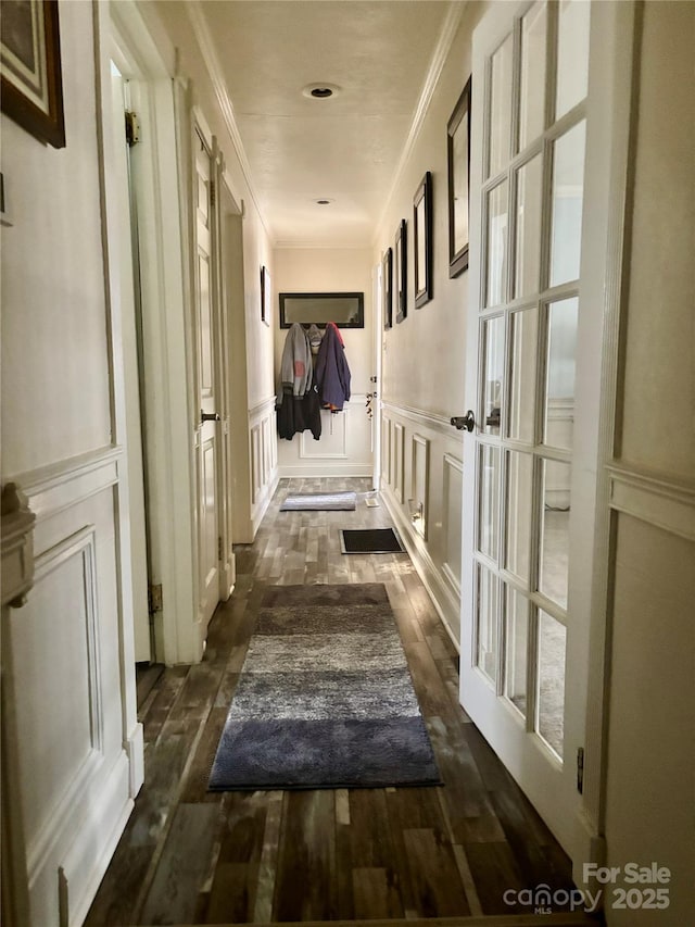 hallway featuring crown molding and dark wood-type flooring