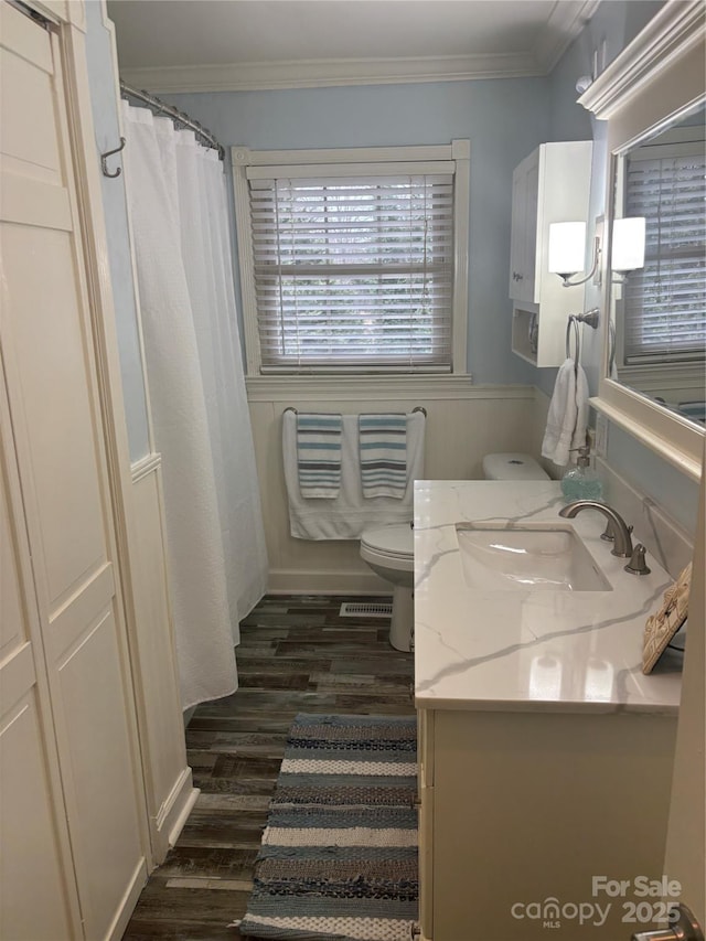 bathroom featuring crown molding, vanity, toilet, and hardwood / wood-style flooring