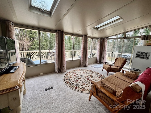 sunroom / solarium with vaulted ceiling with skylight