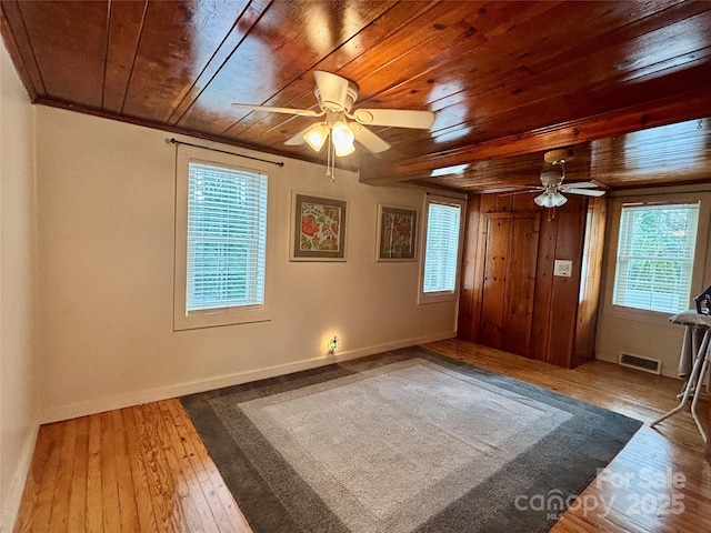 unfurnished bedroom featuring crown molding, hardwood / wood-style floors, and wooden ceiling