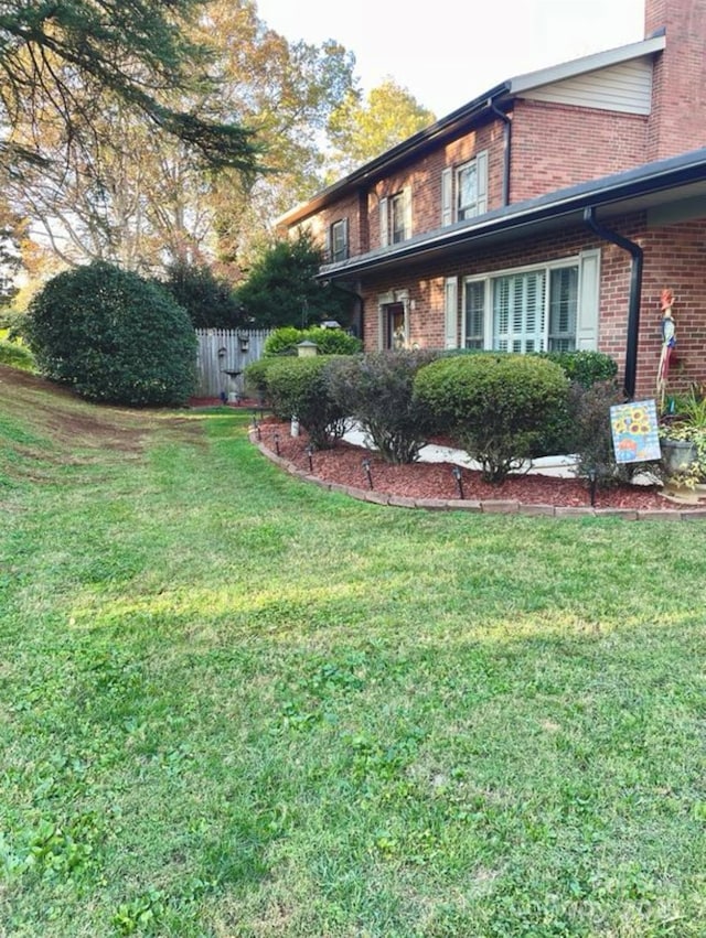 view of property exterior with a lawn