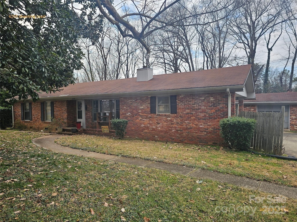 ranch-style home with a front lawn