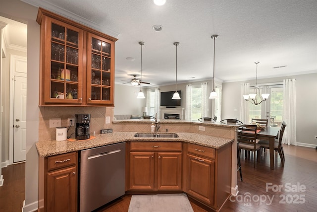 kitchen with sink, a breakfast bar, dishwasher, light stone counters, and kitchen peninsula