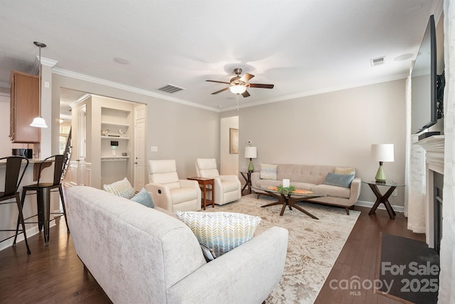 living room with crown molding, ceiling fan, and dark hardwood / wood-style flooring