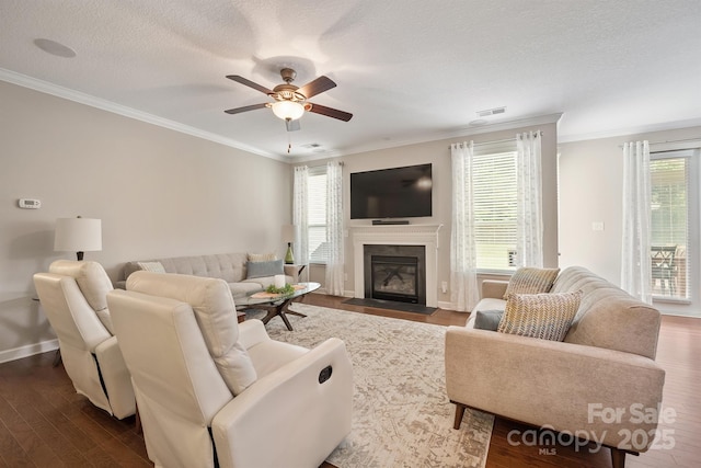 living room with hardwood / wood-style flooring, ornamental molding, and a textured ceiling