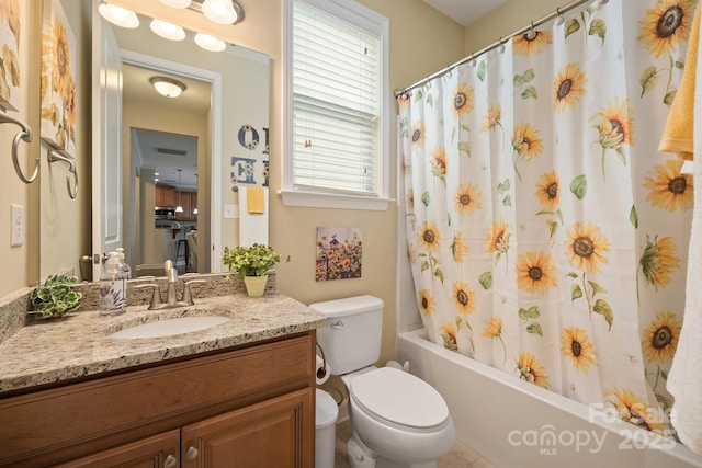 full bathroom featuring vanity, shower / bath combination with curtain, and toilet