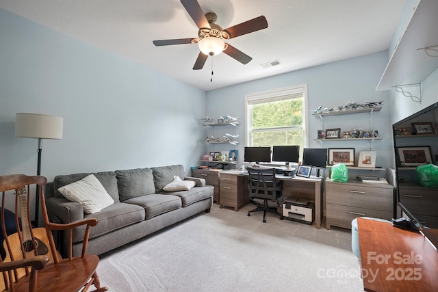 carpeted office featuring ceiling fan