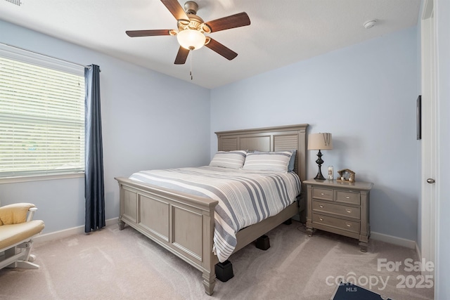 bedroom featuring light colored carpet and ceiling fan