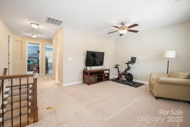 carpeted living room featuring ceiling fan