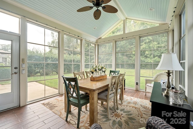 sunroom / solarium featuring ceiling fan and vaulted ceiling with beams