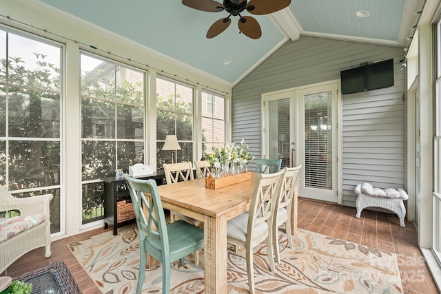 sunroom with lofted ceiling with beams and ceiling fan