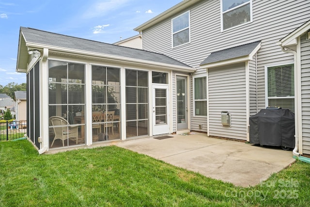 back of house featuring a patio, a yard, and a sunroom