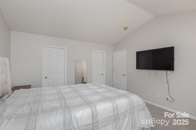 unfurnished bedroom with carpet and lofted ceiling