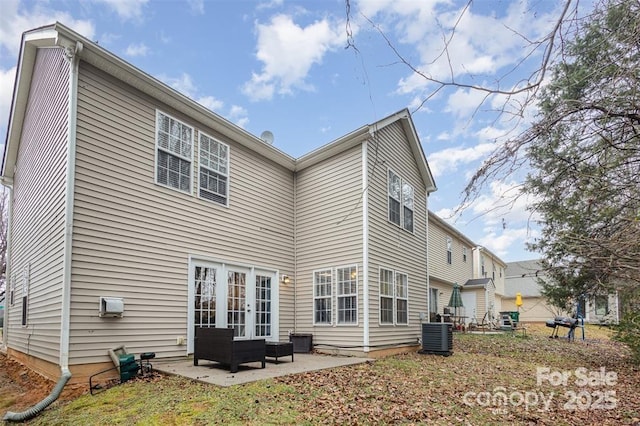 rear view of house featuring french doors, a patio, and central air condition unit