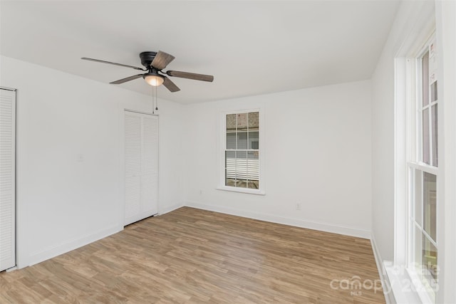 unfurnished room with light wood-type flooring and ceiling fan