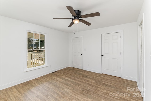 unfurnished bedroom featuring hardwood / wood-style floors and ceiling fan