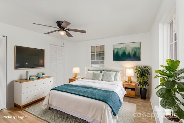 bedroom featuring ceiling fan, light hardwood / wood-style floors, and a closet